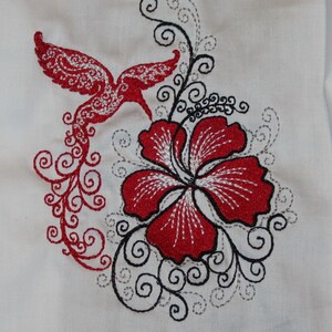 May include: Embroidered design featuring a red hummingbird with a long tail, a red hibiscus flower, and black and gray swirling vines.