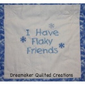 May include: White quilted fabric with blue snowflake border and blue embroidery that reads "I Have Flaky Friends". The fabric is made by Dreammaker Quilted Creations.