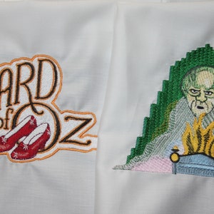 May include: Embroidered patch set featuring "The Wizard of Oz" text with ruby slippers and a green-screened image of the Wizard of Oz.