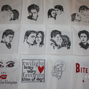 May include: A set of 10 white fabric squares with black and red embroidered designs featuring characters and quotes from the Twilight saga. The designs include a wolf, a vampire, a heart, and the text "twilight is my very favorite time of day!" and "Bite Me".