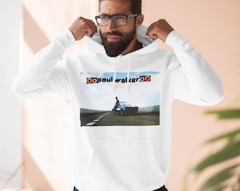 May include: White hoodie with a graphic print of a man standing next to a blue car. The text "oopaul walkeroo" is printed in orange on the hoodie.