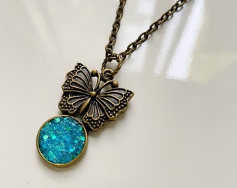 Teal glitter butterfly necklace with bronze chain