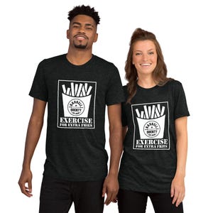 May include: Two people wearing black t-shirts with a white graphic of french fries and the text "Barbell Society Est. 2020 Exercise for Extra Fries".