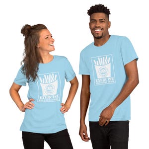 May include: Two people wearing light blue t-shirts with a white graphic of french fries in a box. The graphic includes the text "Barbell Society" and "Exercise for extra fries".
