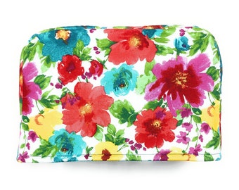 Funda protectora reversible para tostadora de 4 rebanadas con diseño floral en tonos rosa, rojo, amarillo, verde azulado, turquesa y verde con hojas.