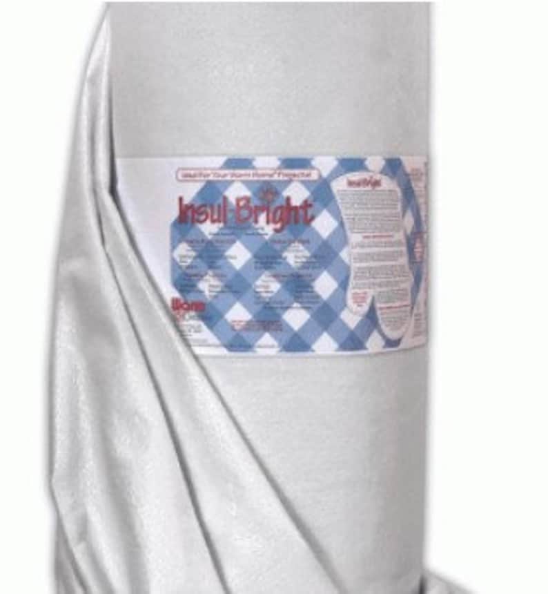 May include: A roll of white Insul-Bright batting, a heat-resistant fabric used for quilting and crafts. The label reads "Insul-Bright" and features a blue and white checkered pattern.