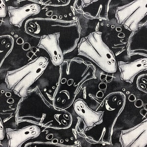 May include: Black and white Halloween-themed fabric featuring a repeating pattern of cartoon ghosts. The ghosts have simple, expressive faces and are surrounded by white, swirly lines. The fabric has a dark gray and black background.