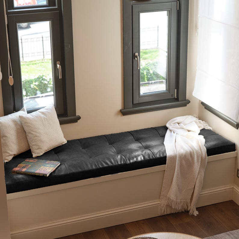 Tufted window bench seat cushion styled on a bright window nook with cozy pillows and natural sunlight.