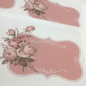 May include: Pink and white floral labels with a vintage design. Each label features a pink background with a decorative border and a bouquet of roses in shades of pink and cream. The labels are ideal for crafts and gifts.