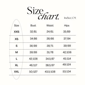 Peut inclure: Tableau des tailles pour les v&ecirc;tements avec des mesures en pouces et en centim&egrave;tres. Le tableau montre les tailles du XXS au XXL avec les mesures de buste, de taille et de hanches correspondantes.