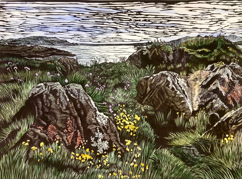 May include: A woodblock print of a rocky seascape with a view of a body of water and distant mountains. The foreground features a variety of green plants and wildflowers, including yellow and purple blooms.