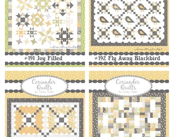 May include: Four quilt patterns by Coriander Quilts are displayed. The quilts feature geometric designs in shades of yellow, gray, and white. Each quilt is labeled with a title and number, including "Joy Filled" and "Fly Away Blackbird."