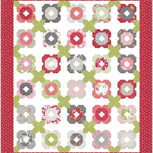 May include: A patchwork quilt featuring a repeating floral pattern in red, pink, grey, and green on a white background. The quilt is bordered with red fabric with small white dots. The design combines geometric shapes with floral motifs, creating a visually appealing textile.