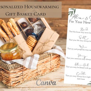 May include: A woven wicker gift basket filled with gourmet food items, including breadsticks, cookies, and a jar of preserves. A personalized housewarming card is displayed next to the basket, with text that reads "Alex & John For Your New Home."