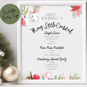 May include: A framed Christmas-themed sign with the text "Have Yourself a Merry Little Cocktail." The sign features a cocktail menu with three drink options. A small Christmas tree and ornaments are on the left.