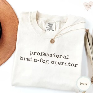 May include: A set of three ceramic mugs with a speckled, matte finish. The mugs are in shades of cream, light grey, and dark grey. Each mug has a simple, minimalist design, ideal for coffee or tea.