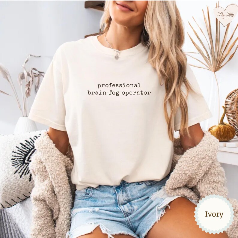 May include: A white ceramic mug with a black handle and the text "But First, Coffee" in a black, bold font. The mug is likely 325 ml in size and sits on a white surface.