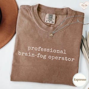 May include: A rustic wooden sign with the text "Welcome to our home" in white lettering. The sign has a distressed finish and a simple, inviting design, ideal for front door decor.