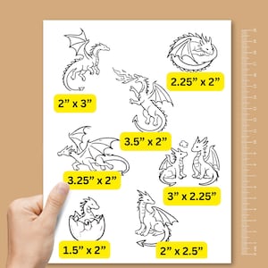 May include: A white sheet featuring seven black line art dragon illustrations with yellow labels indicating dimensions: 2" x 3", 2.25" x 2", 3.5" x 2", 3.25" x 2", 3" x 2.25", 1.5" x 2", and 2" x 2.5". A vertical 20 cm ruler is visible on the right side.