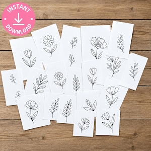 May include: A collection of white rectangular cards featuring black line art illustrations of various flowers, leaves, and botanical sprigs. Each card displays a unique floral design, including daisies, tulips, and leafy stems, arranged in a scattered layout.
