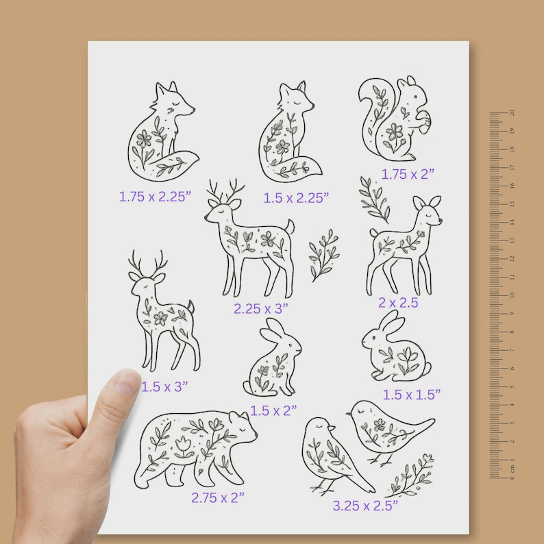 May include: A white sheet featuring black line art illustrations of woodland animals including foxes, a squirrel, deer, rabbits, a bear, and birds, each decorated with floral patterns. Dimensions in inches are printed below each design.