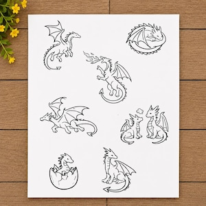 May include: A white sheet of paper featuring seven black line art illustrations of dragons in various poses. The drawings include a flying dragon, a fire-breathing dragon, a curled-up dragon, a dragon hatching from an egg, and two dragons interacting.