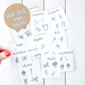 May include: A collection of white paper labels with hand-drawn illustrations of herbs and spices, including cilantro, oregano, thyme, and rosemary. The labels are labeled with the words "Stick + Stitch mini motifs" and "kitchen herbs".