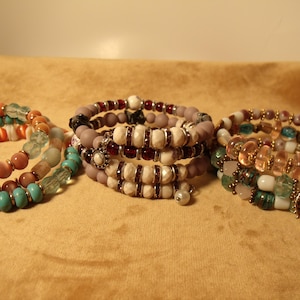 Puede incluir: Cuatro pulseras de varios niveles con cuentas de varios colores, incluyendo turquesa, blanco, marrón, rosa y rojo. Las pulseras están hechas de cuentas de vidrio, metal y piedra.