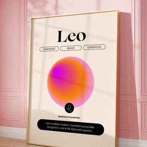 Könnte beinhalten: Ein gerahmter Druck mit dem Wort "Leo" oben und den Wörtern "Confident", "Brave" und "Generous" darunter. Eine rosa-orangefarbene Gradientenkugel ist zentriert. Der Text "Manifestation Mantra" und ein Zitat befinden sich unten.