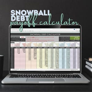 May include: A laptop displaying a spreadsheet titled "SNOWBALL DEBT CALCULATOR." The screen shows rows and columns of financial data, with the words "SNOWBALL" and "payoff calculator" above the screen. The laptop is on a dark surface.