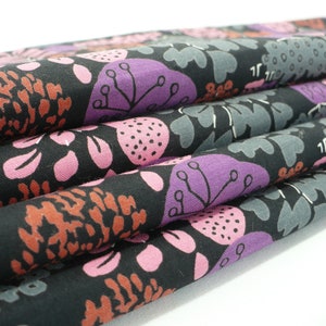May include: Black fabric with a floral pattern featuring pink, purple, and brown flowers on a black background.