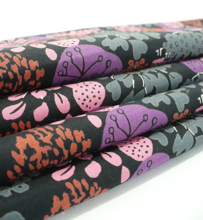 May include: Black fabric with a floral pattern featuring pink, purple, and brown flowers on a black background.