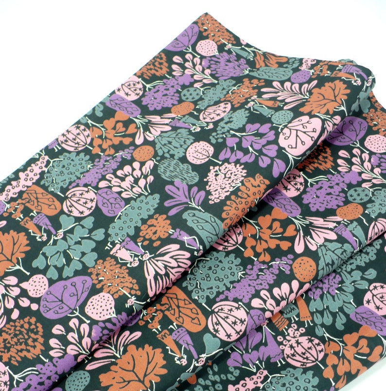 May include: Black fabric with a repeating pattern of stylized flowers, leaves, and figures in shades of pink, purple, brown, and green.