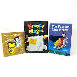 May include: Three vintage children's books. The covers are brightly coloured and feature the titles "Monster Jokes and Riddles", "Spooky Magic", and "The Peculiar Miss Pickett". Illustrations include monsters, magic, and a witch.