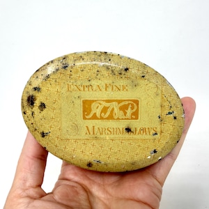 May include: A white ceramic mug with a black handle and the text "But First, Coffee" in a black, handwritten-style font. The mug is on a white surface.