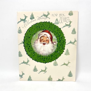 Cartão de Natal vintage de Papai Noel por Majorie Cooper, barba de penas brancas, guirlanda flocada