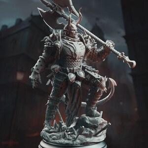 May include: A detailed figurine of a horned demon warrior, clad in ornate armor and wielding a large battle axe. The figure is posed on a rocky base, with a menacing expression. The color palette is primarily shades of gray and silver, with a dark background.