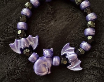 Purple Metallic finish plastic cat and bat bracelet on elastic chord