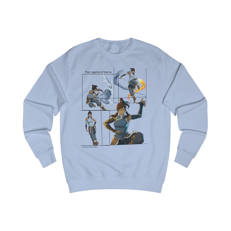 May include: A light blue sweatshirt with a graphic of Korra from The Legend of Korra. The graphic shows Korra in four different poses, each representing a different element: water, earth, fire, and air. The text 'The Legend of Korra' is printed above the graphic.