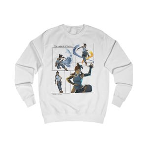 May include: White long-sleeved sweatshirt with a graphic print of Avatar Korra in different poses. The text 'The Legend of Korra' is printed above the graphic. The text 'Echoes of the Moon' is printed below the graphic.