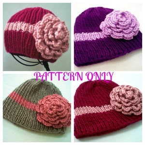 May include: Four knitted hats with a flower embellishment. The hats are in different colors, including purple, red, green, and brown. Each hat has a contrasting band of pink yarn. The flowers are all pink and have a crocheted texture.