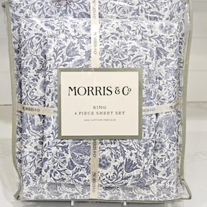 May include: A packaged King size 4-piece sheet set by Morris & Co. The sheets feature a blue and white floral pattern. The packaging includes the brand name and product details. Made of 100% cotton percale.