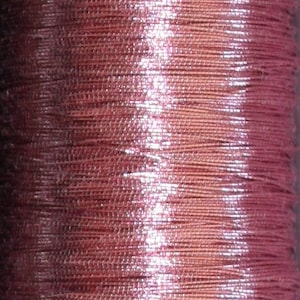May include: A spool of metallic pink thread with a silver sheen.