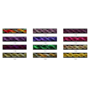 May include: A collection of 12 embroidery floss spools in various colours, including red, green, purple, gold, and brown. The spools are arranged in three rows of four, with each spool labelled with a number.
