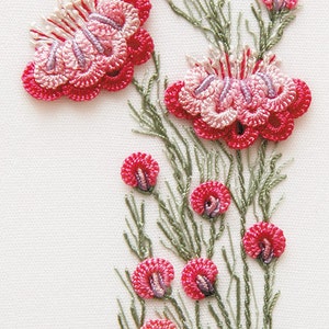 May include: Embroidered floral design featuring red and pink flowers with green stems and leaves. The flowers have a detailed, textured appearance, with a mix of light and dark pink threads. The background is a plain white fabric.