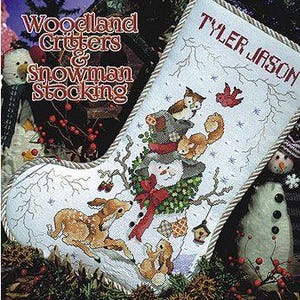 May include: A cross-stitch Christmas stocking with a snowman and woodland creatures, and the name "Tyler Jason." The design includes a deer, owl, squirrel, and a red bow. The stocking is white with a decorative border and is part of the "Woodland Critters & Snowman Stocking" collection.