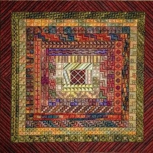 May include: A colorful square quilt with a geometric pattern. The quilt is made up of various shades of red, orange, yellow, green, and purple. The center of the quilt features a smaller square with a more intricate design.