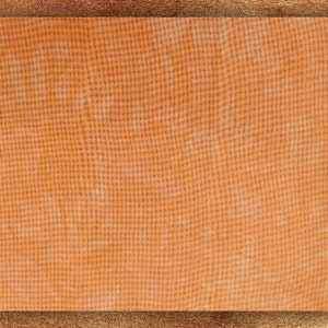 May include: A close-up of a textured orange fabric with a subtle pattern. The fabric has a slightly rough texture and a warm, earthy tone.