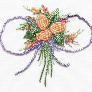 May include: A purple embroidered bow with a cluster of orange and pink flowers in the center.