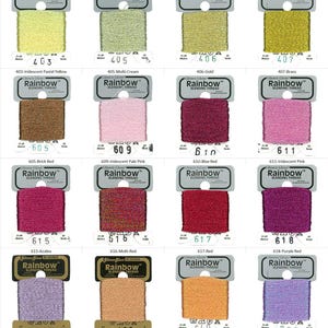 May include: A collection of 10 spools of Rainbow Glissen Gloss Blending Thread. The spools are arranged in a grid of four rows and three columns. Each spool has a different color of thread, including pastel yellow, cream, gold, brass, brick red, pale pink, blue red, iridescent pink, azalea, multi-red, red, purple red, grey pink, salmon, apricot, and violet.